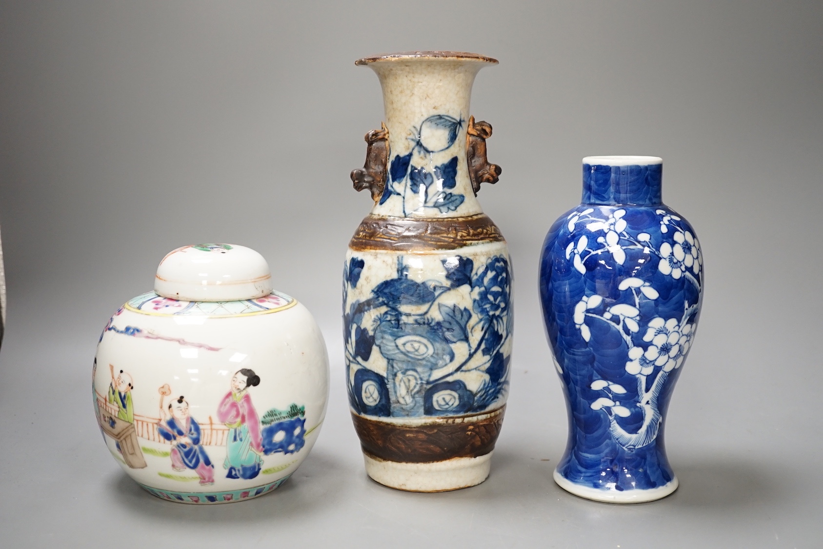 A 19th century Chinese blue and white prunus jar, a crackle glaze vase and a famille rose jar and cover